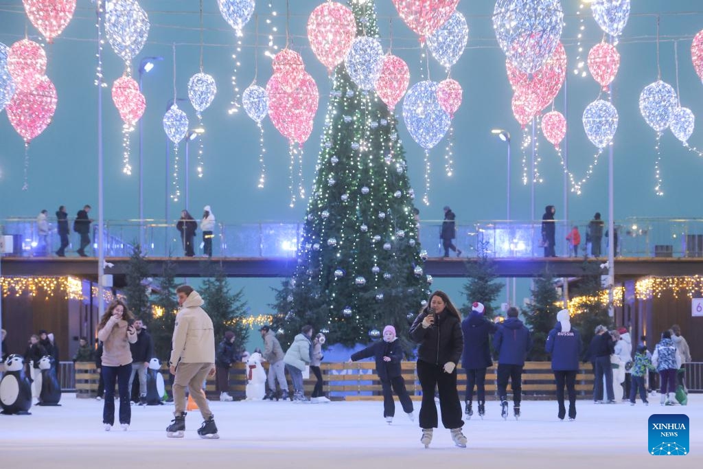 People skate at the Flagpole ice rink in St. Petersburg, Russia, on Dec. 6, 2025. St. Petersburg's Flagpole ice rink officially opened for the season on Saturday. Situated along the Gulf of Finland, the 28,000-square-meter rink is one of the world's largest artificial ice rinks and one of the most popular winter attractions in St. Petersburg. (Photo by Irina Motina/Xinhua)