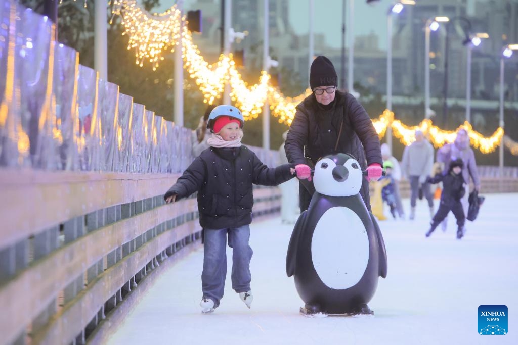 People skate at the Flagpole ice rink in St. Petersburg, Russia, on Dec. 6, 2025. St. Petersburg's Flagpole ice rink officially opened for the season on Saturday. Situated along the Gulf of Finland, the 28,000-square-meter rink is one of the world's largest artificial ice rinks and one of the most popular winter attractions in St. Petersburg. (Photo by Irina Motina/Xinhua)