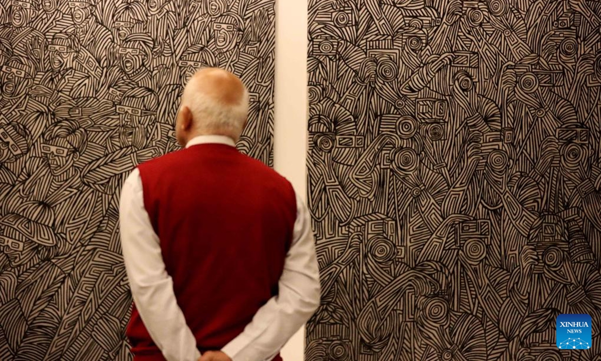 A man views an exhibit at the Arab Art Fair in Beirut, Lebanon, Dec. 4, 2025. The fair offers visitors a unique journey through the colors and stories of contemporary Arab art. (Xinhua/Bilal Jawich)