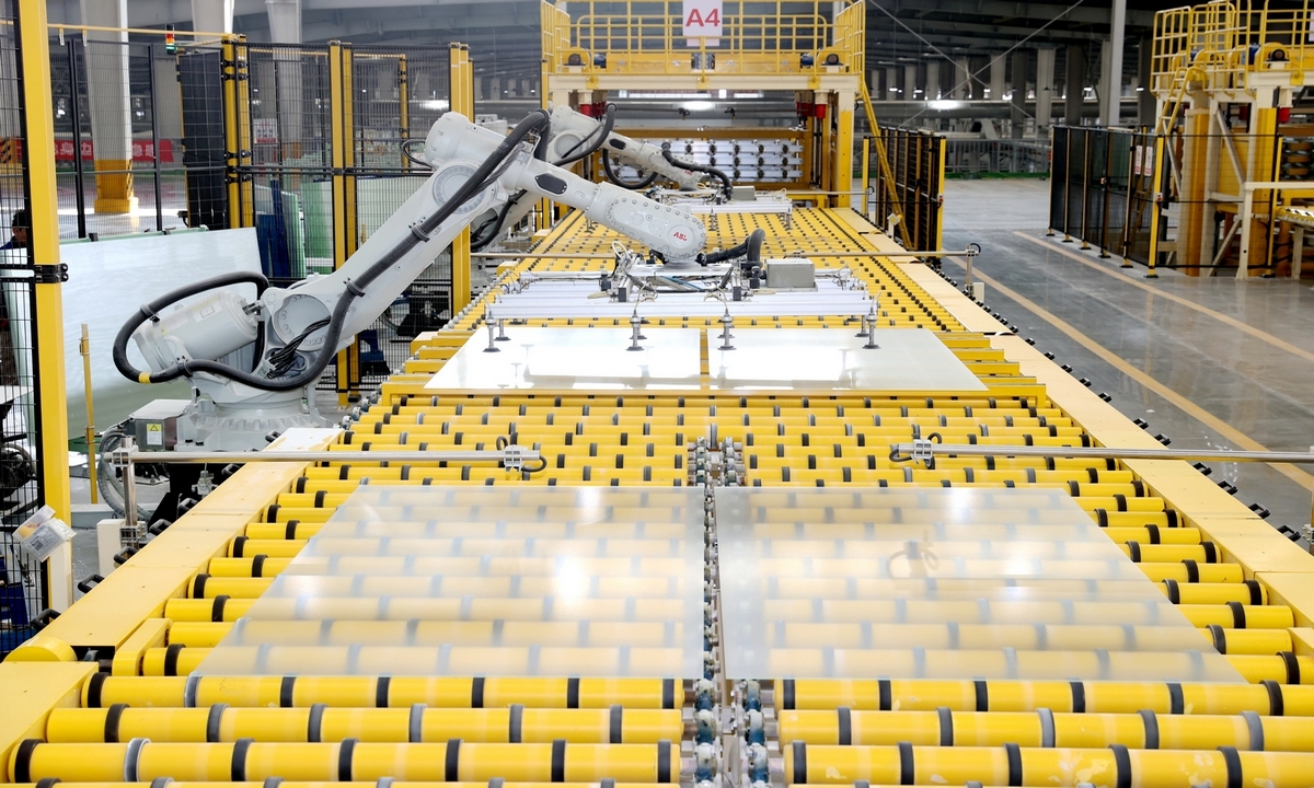 Robotic arms whirl and flip, stacking sheets of glass on a smart production line in Suqian, East China's Jiangsu Province, on December 10, 2025. Since the fourth quarter began, firms have been running machines at full tilt, chasing orders and expanding capacity to power industrial growth through the final sprint of 2025. Photo: VCG