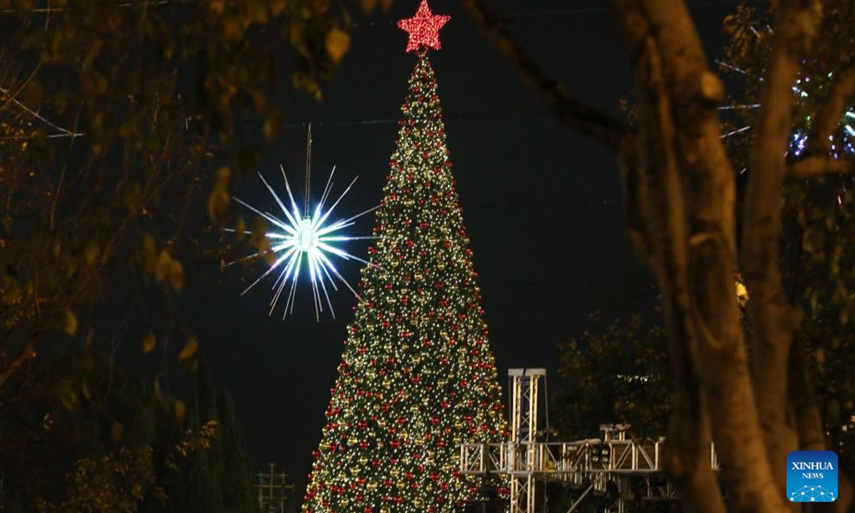 A Christmas tree is lit at the Manger Square in Bethlehem, southern West Bank on Dec. 6, 2025. Hundreds of residents and visitors attended a Christmas tree-lighting event here Saturday to mark the beginning of this year's Christmas celebrations. (Photo by Mamoun Wazwaz/Xinhua)