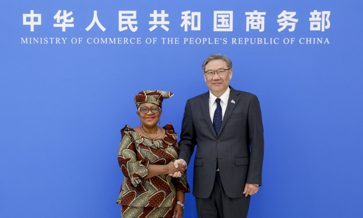 China's Commerce Minister Wang Wentao shakes hand with WTO Director-General Ngozi Okonjo-Iweala in Beijing on December 8, 2025. Photo: Official website of the Ministry of Commerce