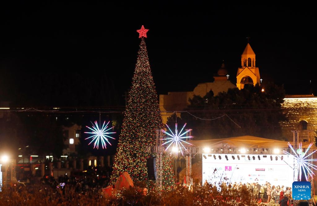 A Christmas tree is lit at the Manger Square in Bethlehem, southern West Bank on Dec. 6, 2025. Hundreds of residents and visitors attended a Christmas tree-lighting event here Saturday to mark the beginning of this year's Christmas celebrations. (Photo by Mamoun Wazwaz/Xinhua)