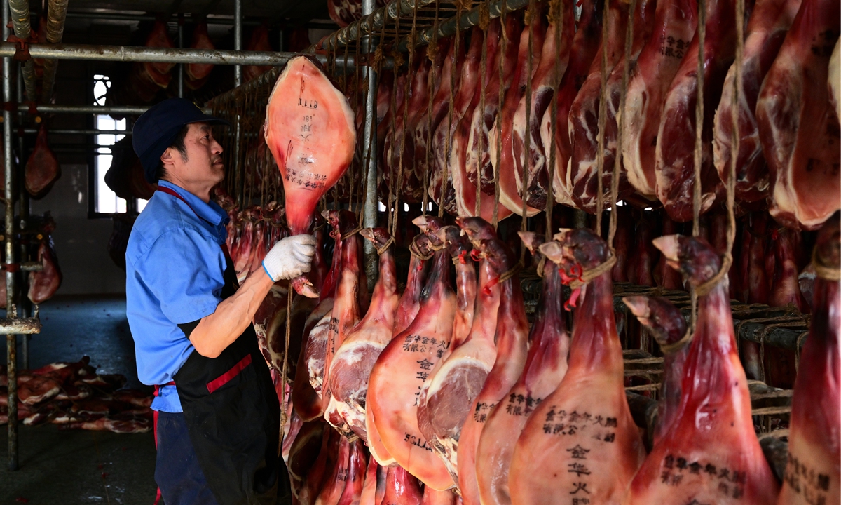 A worker sorts Jinhua Ham at a food processing company in Jinhua, East China's Zhejiang Province, on December 7, 2025. Jinhua Ham's 1,000-year-old craftsmanship involves more than 80 traditional steps and more than three months of curing, making it a favorite among consumers at home and abroad. The technique is listed as a national intangible cultural heritage and the product holds a national geographical indication. Photo: VCG