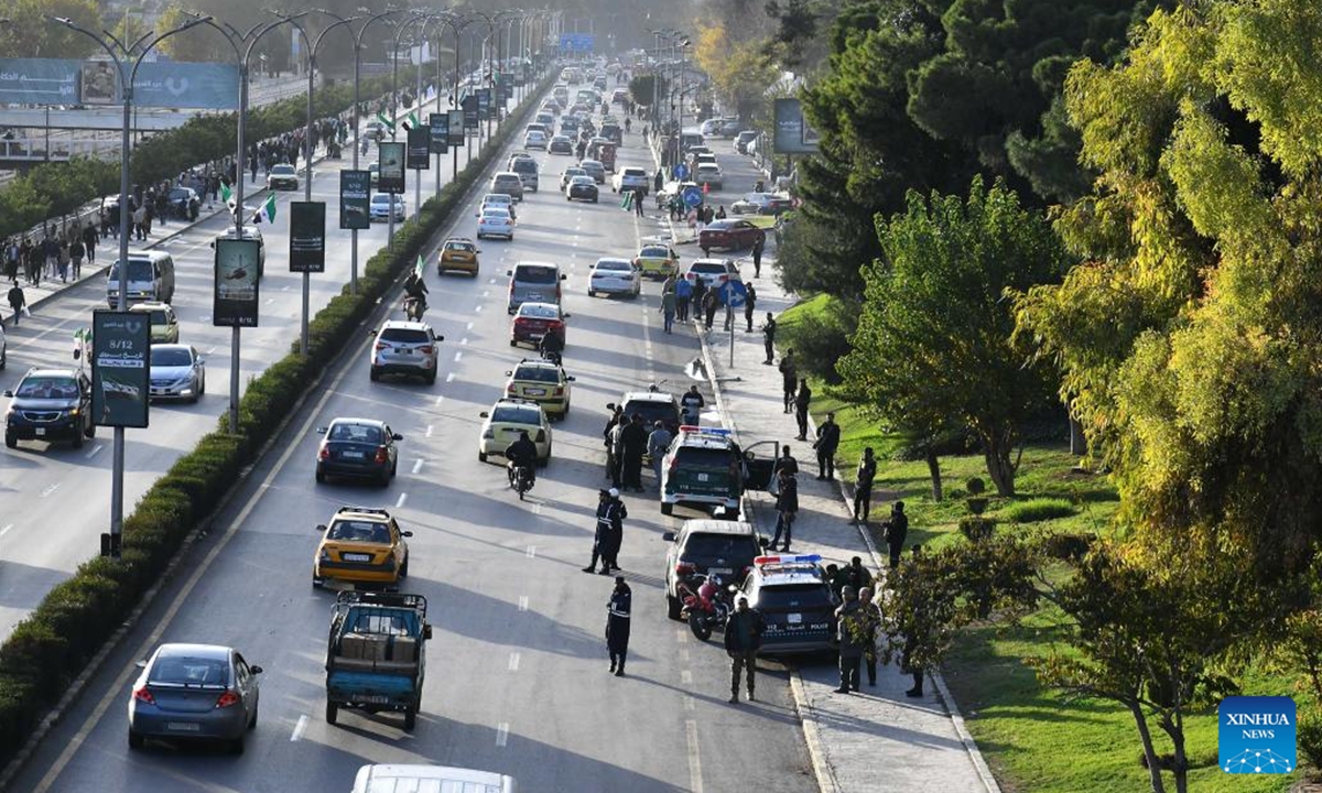 Policemen are seen on alert at the explosion site of a sound bomb in Damascus, Syria, Dec. 7, 2025. An explosion shook the Syrian capital of Damascus on Sunday, according to local witnesses. Local media said the blast was caused by a sound bomb near the Freedom Bridge -- formerly the President Bridge -- in the heart of the city. No damage or injuries were reported. (Photo by Ammar Safarjalani/Xinhua)