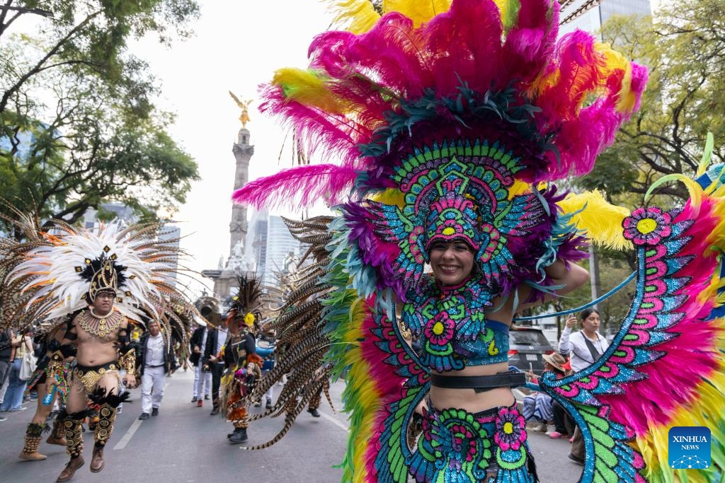 Performers march in costumes during the Villa-Zapata carnival in Mexico City, Mexico, on Dec. 6, 2025. The 11th Villa-Zapata carnival was hosted in Mexico City on Saturday. Folkloric dances, traditional music, and street processions were seen along the Paseo de la Reforma avenue during the event, promoting traditional Mexican culture while paying tribute to revolutionary leaders Emiliano Zapata and Francisco Villa in the Mexican Revolution of 1910-1920. (Xinhua/Li Mengxin)
