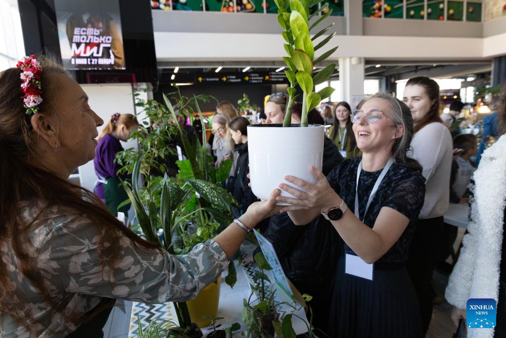 People visit a plant and flower market in Vladivostok, Russia, Dec. 7, 2025. (Photo by Andrey Matveenko/Xinhua)