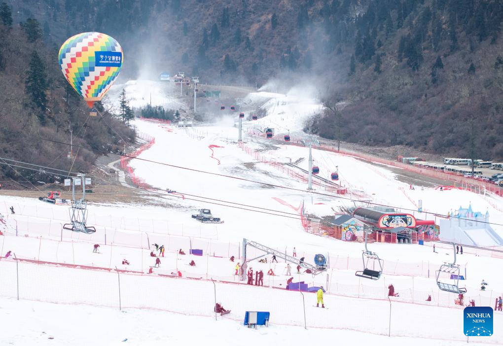 An aerial drone photo taken on Dec. 8, 2025 shows people having fun at Qiangrengu ski resort in Wenchuan County, Aba Tibetan and Qiang Autonomous Prefecture, southwest China's Sichuan Province. The 2025 Sichuan Winter Tourism Season kicked off here on Monday. Sichuan has launched four major tourism routes and more than 5,000 winter cultural and tourism activities to enrich visitors' winter travel experience. (Xinhua/Jiang Hongjing)