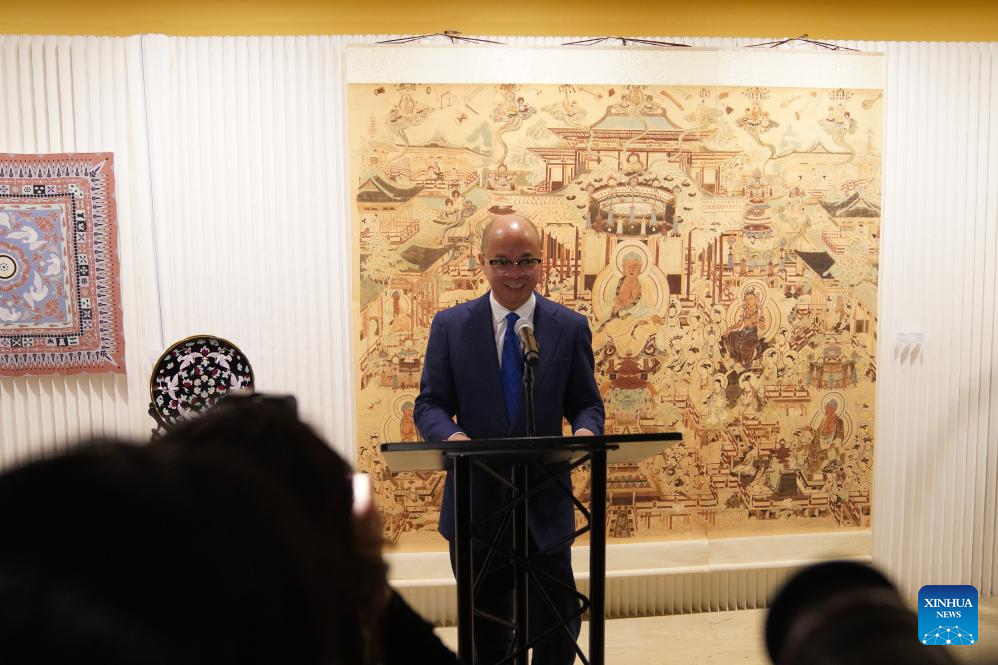 Yu Yougen, education counselor at the Chinese Consulate General in New York, addresses an exhibition showcasing Tsinghua University's research and design work inspired by the ancient art of Dunhuang at the UN headquarters in New York, Dec. 8, 2025. More than 80 works are on display at the exhibition, from early masters such as Pang Xunqin, Chang Sha'na, Chen Hanmin and Liu Jude, to new pieces by Tsinghua students and alumni. (Xinhua/Zhang Fengguo)