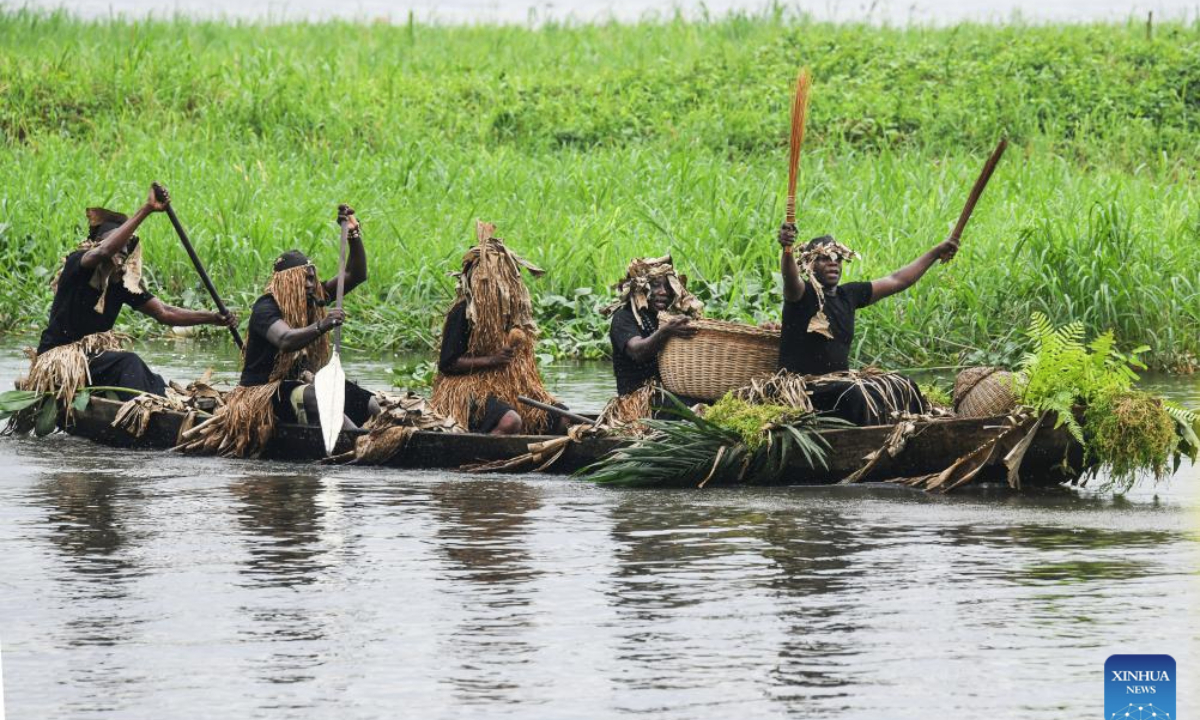 Devotees of Sawa culture carry a sacred vase during the Ngondo Festival in Douala, Cameroon, on Dec. 7, 2025. Thousands recently gathered along the banks of the Wouri River in Cameroon's commercial hub, Douala, to witness the Ngondo Festival, as the Sawa community's iconic river ritual marked its first anniversary as a globally renowned intangible cultural heritage. (Xinhua/Kepseu)