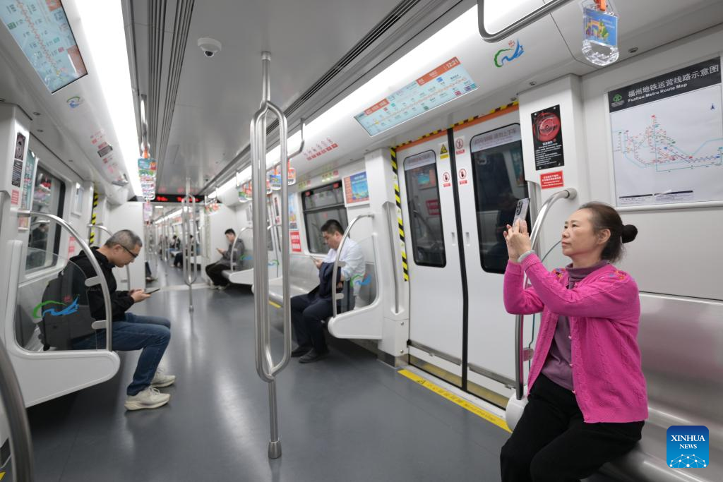 Passengers are seen aboard a train of Fuzhou Metro Line 4 in Fuzhou City, southeast China's Fujian Province, Dec. 10, 2025. The Line 4 of Fuzhou Metro began operation on Wednesday. (Xinhua/Lin Shanchuan)