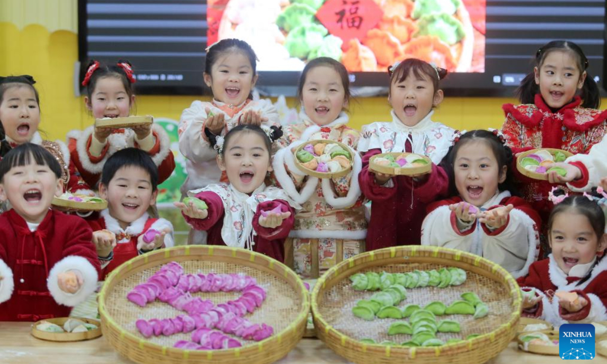 Children display dumplings they have just made at a kindergarten in Yangzhou City, east China's Jiangsu Province, Dec. 18, 2025. People all over the country held diverse events on Thursday to mark the Winter Solstice, which will fall on Dec. 21 this year. Winter Solstice, the shortest day of the year, denotes the beginning of deep winter and a break from farming in traditional agricultural society in Chinese culture. Northern China has maintained the tradition of eating dumplings on this day, while people in southern China eat tangyuan (glutinous rice balls). (Photo by Meng Delong/Xinhua)