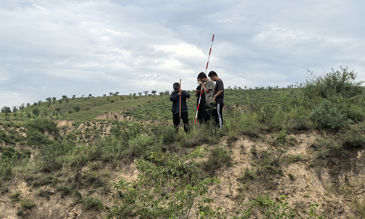 Researchers survey the remains of the road dating back to the Qin Dynasty. Photo: Courtesy of Yulin's institute of cultural relics protection and research