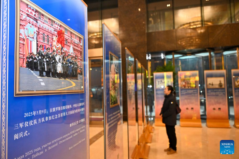 A woman visits a news photo exhibition on China-Russia friendship and cooperation in the new era in Beijing, capital of China, Dec. 15, 2025. A news photo exhibition jointly organized by China's Xinhua News Agency and Russia's TASS News Agency was held in Beijing on Monday. (Xinhua/Jin Liangkuai)