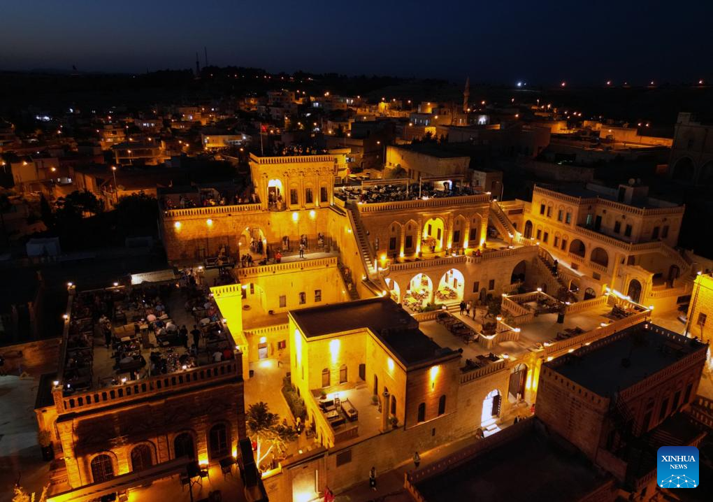 An aerial drone photo taken on Dec. 14, 2025 shows a night view of the historic Anitli neighborhood in Midyat, Mardin province, Türkiye. Anitli has been named one of the Best Tourism Villages 2025 by the United Nations World Tourism Organization (UNWTO), a designation expected to further boost the area's growing tourism momentum. It has preserved its natural charm and is home to historic landmarks that captivate visitors. (Mustafa Kaya/Handout via Xinhua)