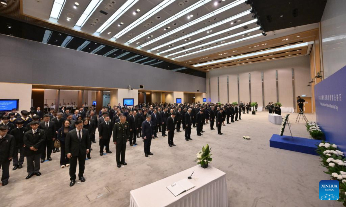 Participants observe a moment of silence at a ceremony mourning the victims of the Nanjing Massacre in south China's Hong Kong, Dec. 13, 2025. (Information Services Department of the Government of the HKSAR/Handout via Xinhua)