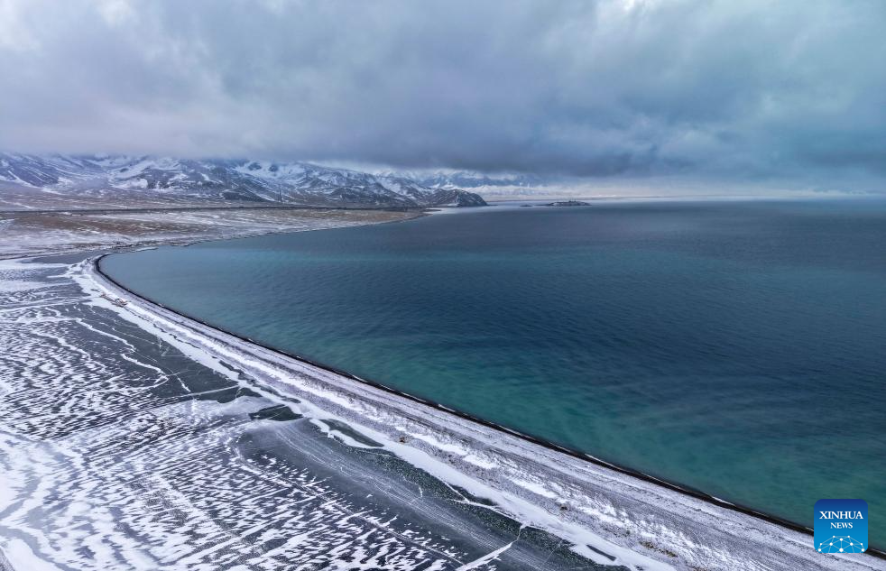 An aerial drone photo taken on Dec. 16, 2025 shows the Sayram Lake and snow mountain in Bortala Mongolian Autonomous Prefecture, northwest China's Xinjiang Uygur Autonomous Region. (Photo by Xu Rui/Xinhua)
