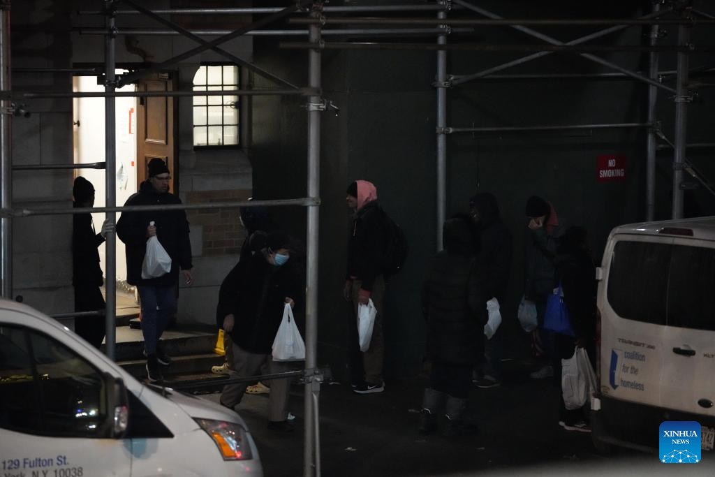 People step out a shelter with free meals in New York City, the United States, Dec. 17, 2025. (Xinhua/Zhang Fengguo)