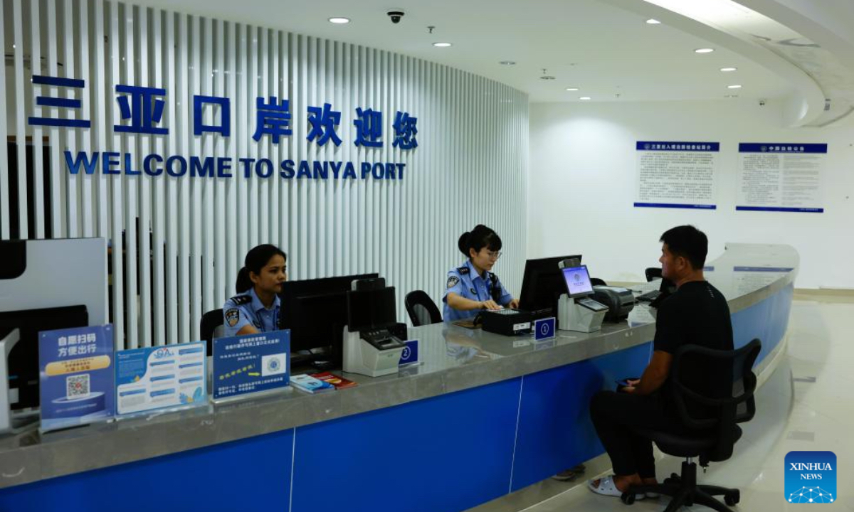 Officers process border procedures for a crew member of a ship in Sanya, south China's Hainan Province, Dec. 18, 2025. China on Thursday launched island-wide special customs operations in the Hainan Free Trade Port (FTP). (Photo by Cong Gao/Xinhua)