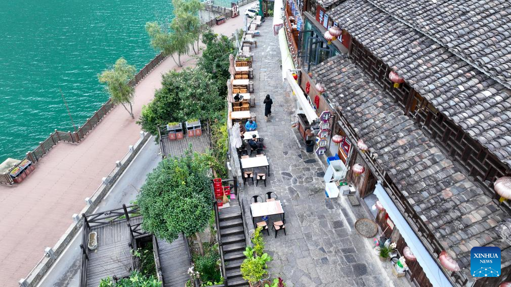 An aerial drone photo taken on Dec. 11, 2025 shows tourists visiting the Gongtan Ancient Town in Youyang Tujia and Miao Autonomous County, southwest China's Chongqing Municipality. (Photo by Qiu Hongbin/Xinhua)
