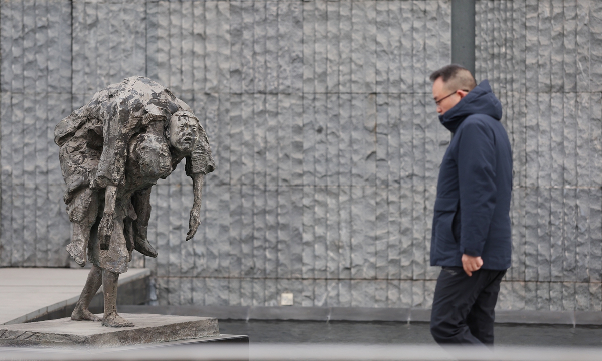 A passer-by walks past the main thematic sculpture at Memorial Hall of the Victims in Nanjing Massacre by Japanese Invaders in Nanjing, East China's Jiangsu Province on December 12, 2025. Photo: Cui Meng/GT