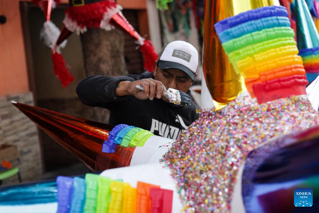 A man makes pinatas outside a family workshop in Mexico City, Mexico, on Dec. 16, 2025. Pinata, traditionally crafted in the shape of a seven-pointed star, is filled with candies and small gifts, bringing joy and festive spirit to celebrations. (Xinhua/Francisco Canedo)