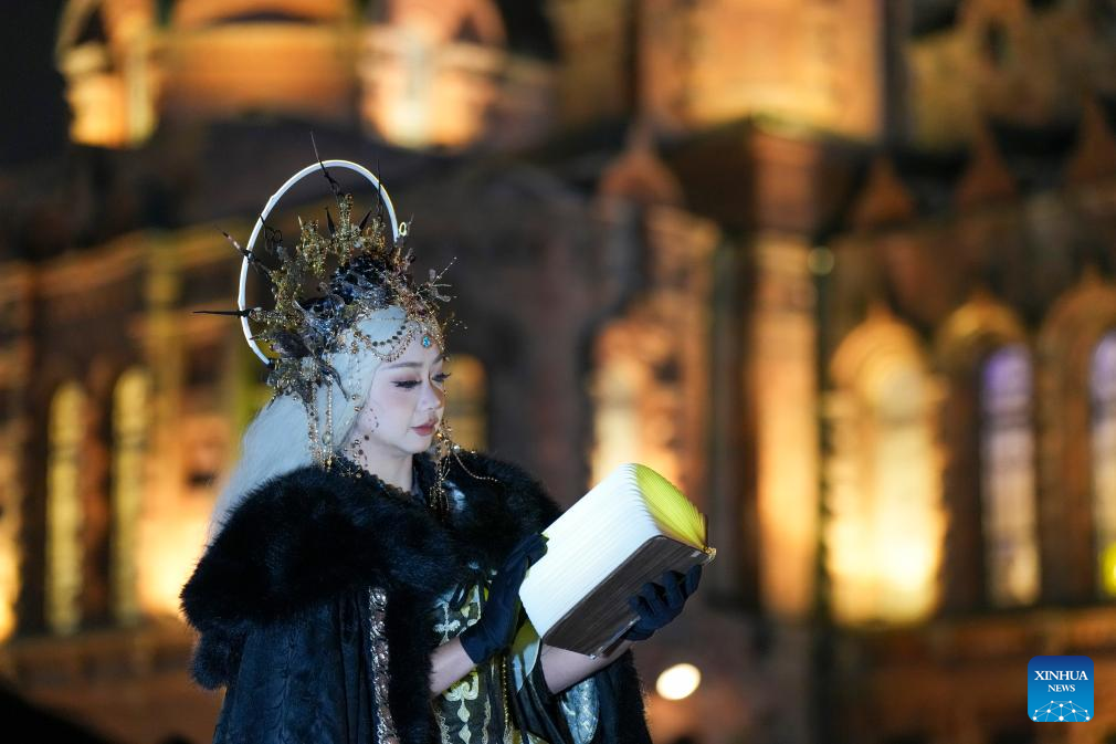 A tourist in costume poses for a photo at a square of architecture art in Harbin, northeast China's Heilongjiang Province, Dec. 15, 2025. The square, where the landmark St. Sophia Cathedral, a former Russian Orthodox church and a perfect example of Neo-Byzantine architectures, is located, has become a hot spot for tourists to take travel photos. (Xinhua/Wang Song)
