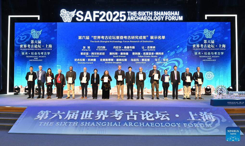 Representatives awarded the Sixth Shanghai Archaeology Forum (SAF2025) Research of Distinction receive certificates at the opening ceremony of the forum in Shanghai, east China, on Dec. 16, 2025. Jointly hosted by the Chinese Academy of Social Sciences, Shanghai Municipal People's Government and the National Cultural Heritage Administration of China, the SAF2025 themed on Technology, Society and Archaeology has attracted nearly 300 experts and scholars from over 40 countries and regions around the world to attend. (Xinhua/Li He)