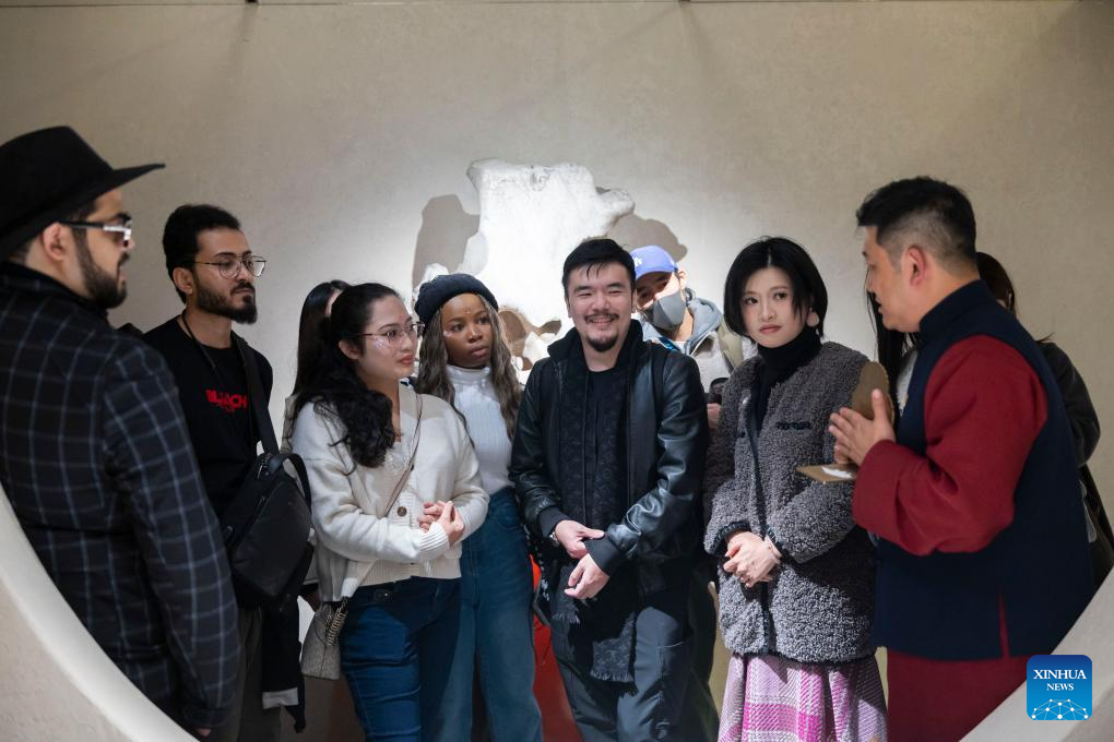 Guests attending the 4th Shanghai International Literature Week visit Tower Shadow, a cultural space in east China's Shanghai, Dec. 17, 2025. (Xinhua/Wang Xiang)