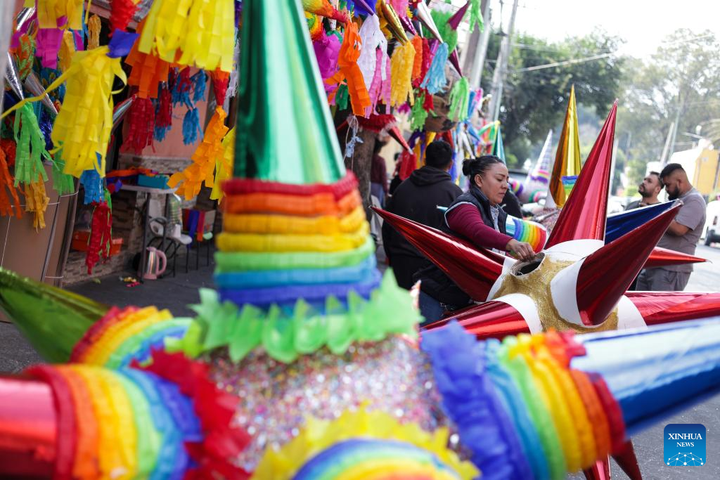 A woman makes pinatas outside a family workshop in Mexico City, Mexico, on Dec. 16, 2025. Pinata, traditionally crafted in the shape of a seven-pointed star, is filled with candies and small gifts, bringing joy and festive spirit to celebrations. (Xinhua/Francisco Canedo)