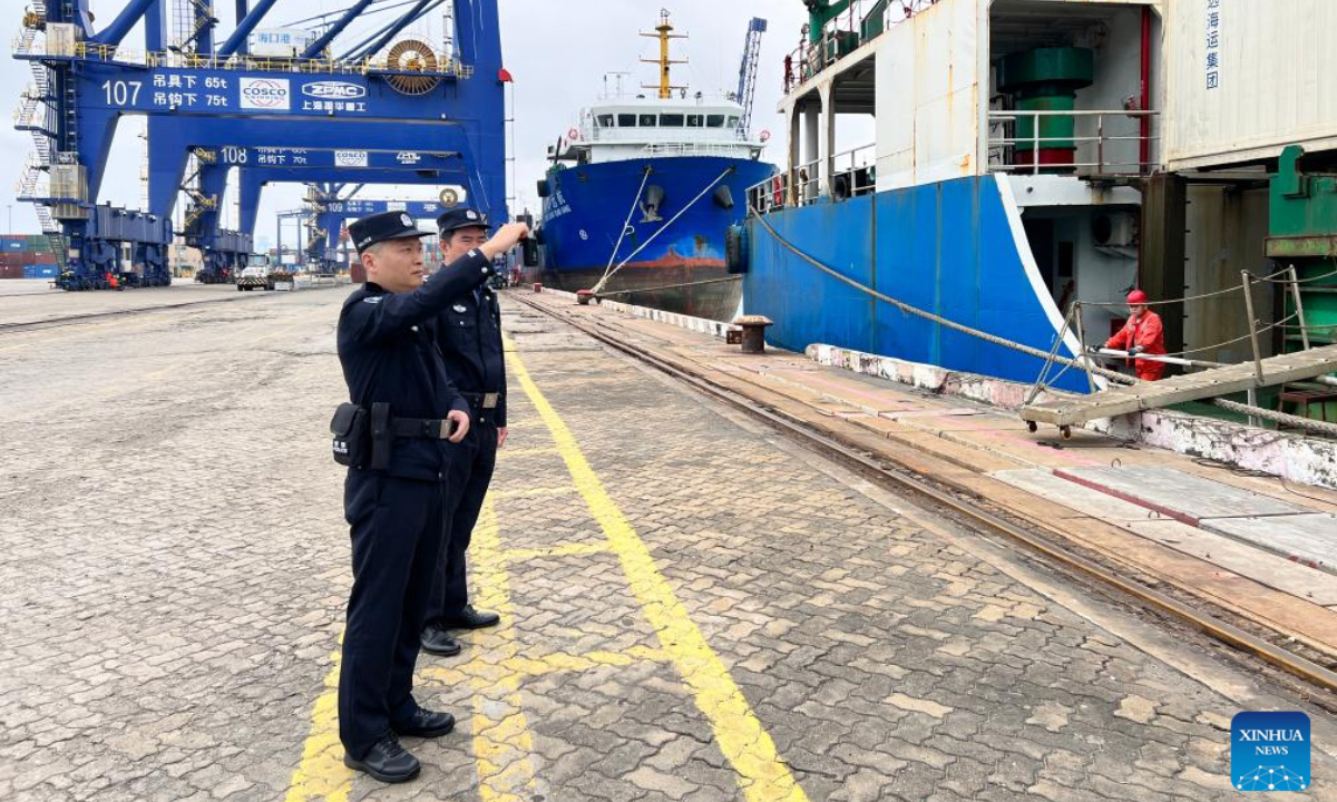 Border inspection officers patrol at a port in Xiuying of Haikou, south China's Hainan Province, Dec. 18, 2025. China on Thursday launched island-wide special customs operations in the Hainan Free Trade Port (FTP). (Photo by Yang Jiyong/Xinhua)