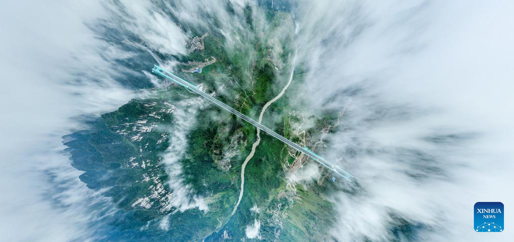 This aerial drone photo taken on Sept. 27, 2025 shows the Huajiang Grand Canyon Bridge in southwest China's Guizhou Province.
Guizhou, the only province in China without a single plain and home to deep ravines, has long relied on tunnels and bridges to overcome its jagged karst landscape.
Since 2012, the province has accelerated its bridge construction endeavors. Guizhou now has over 32,000 bridges either already built or under construction -- a tenfold increase compared to the 1980s.
Due to its sheer number of bridges, diverse bridge types and complex construction technologies, Guizhou has earned the title of the world's bridge museum. (Xinhua/Ou Dongqu)