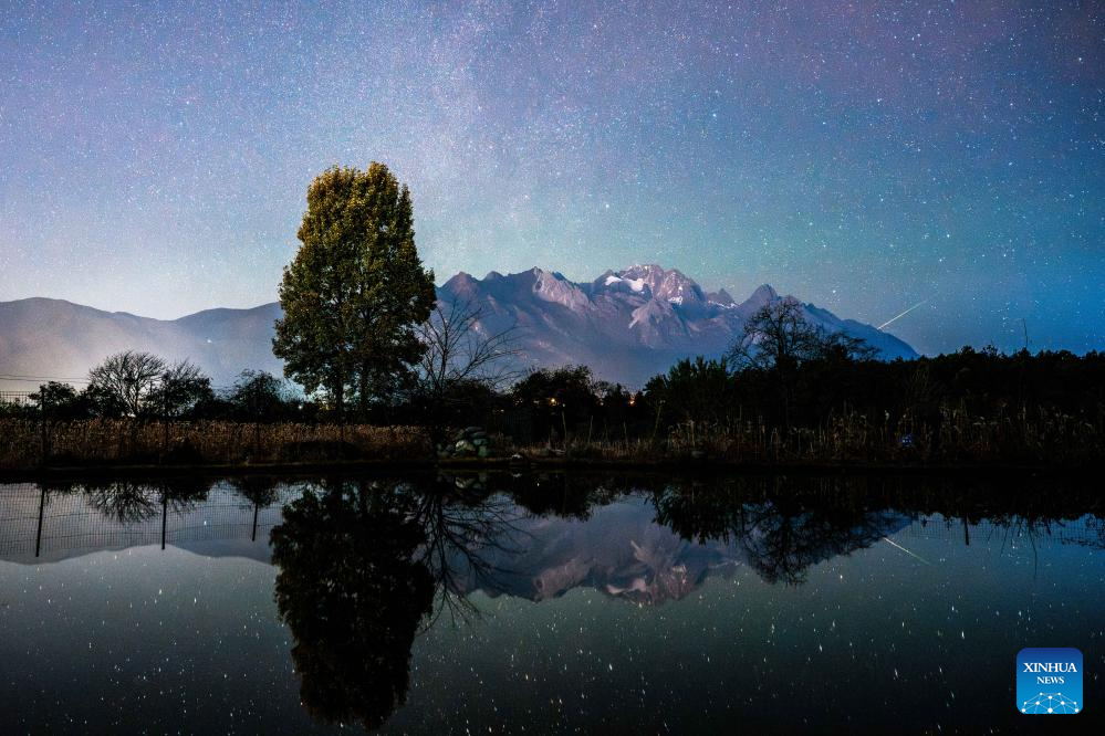 This stack composite photo taken on Dec. 13, 2025 shows the starry sky over Baisha Town of Lijiang City, southwest China's Yunnan Province. The Geminid meteor shower, one of the most spectacular meteor showers of the year, reached its peak on Sunday. (Xinhua/Hu Chao)