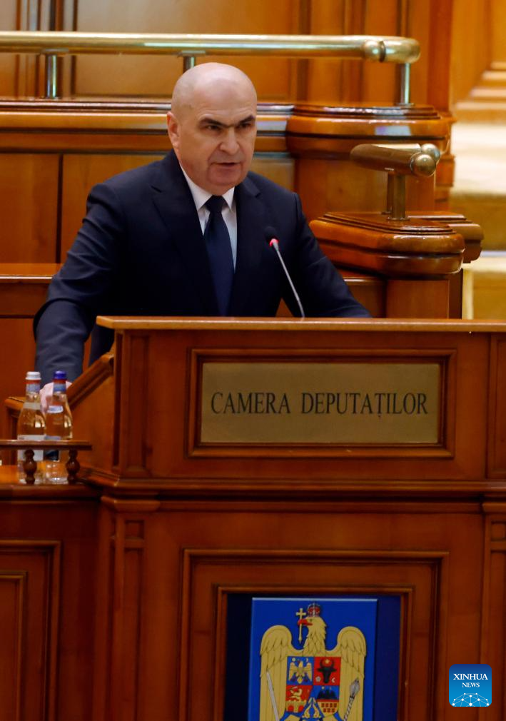 Romania's Prime Minister Ilie Bolojan speaks during a no-confidence motion at Parliament Palace in Bucharest, Romania, Dec. 15, 2025. Romania's parliament on Monday rejected a no-confidence motion against the government of Prime Minister Ilie Bolojan after it failed to secure the required majority in a joint session. (Photo by Cristian Cristel/Xinhua)