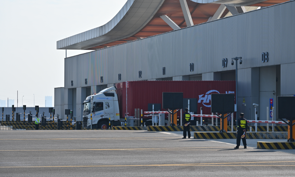 The first cargo truck passes through Xinhai Port in Haikou following the launch of island-wide special customs operations at the Hainan Free Trade Port,on December 18, 2025.