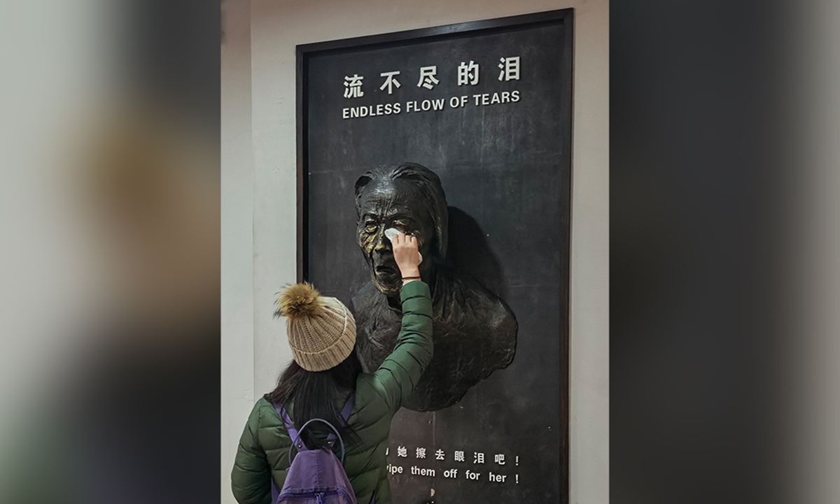 A visitor wipes away the 