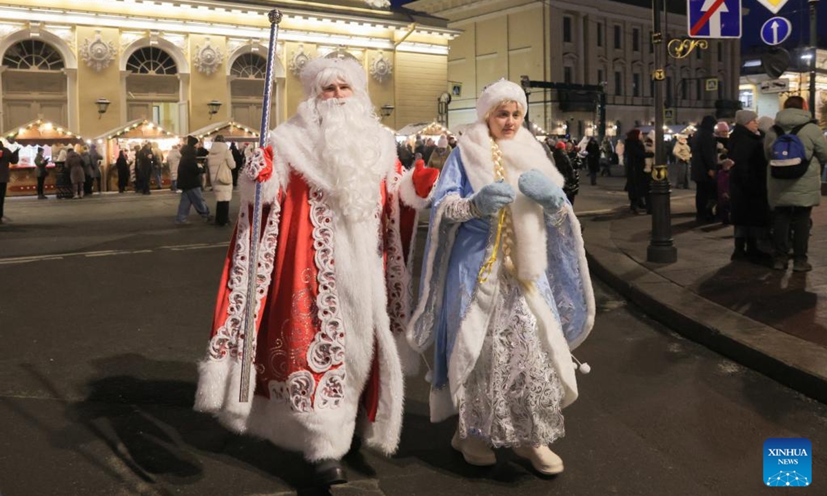People dressed up as Father Frost and Snow Maiden walk through a Christmas market in St. Petersburg, Russia, Dec. 13, 2025. A Christmas market opened here on Saturday for the upcoming Christmas and New Year holidays. (Photo by Irina Motina/Xinhua)