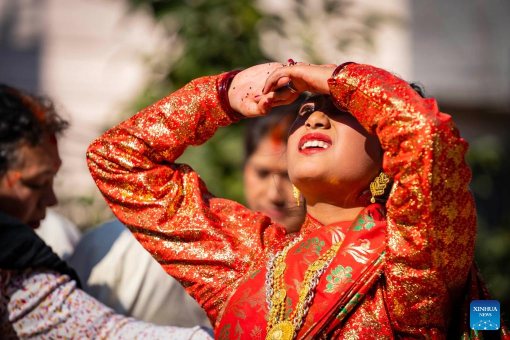 A girl worships the Sun during a puberty ceremony known as Gufa in Lalitpur, Nepal, on Dec. 13, 2025. (Photo by Hari Maharjan/Xinhua)