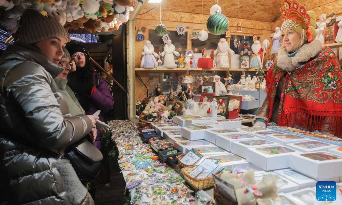 Tourists buy souvenirs at a Christmas market in St. Petersburg, Russia, Dec. 13, 2025. A Christmas market opened here on Saturday for the upcoming Christmas and New Year holidays. (Photo by Irina Motina/Xinhua)
