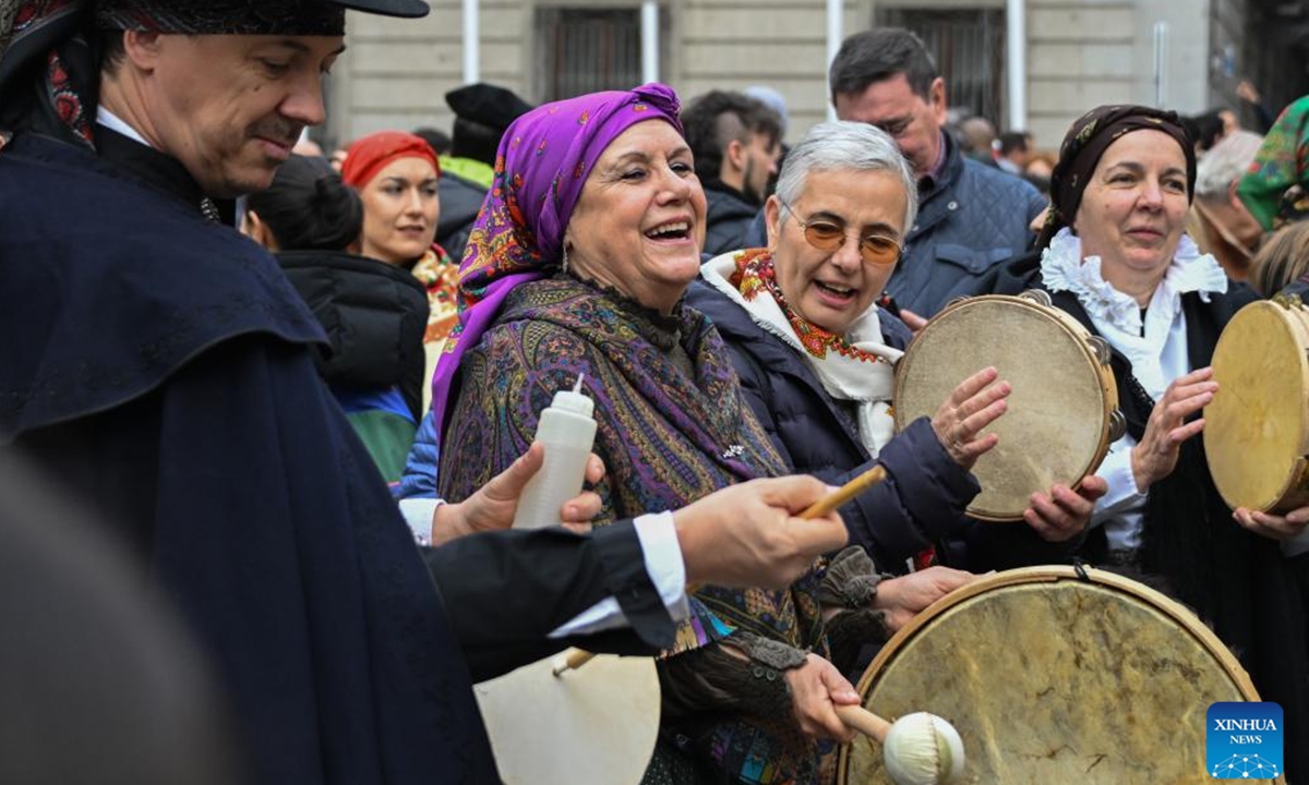 Members of a folk group perform during a music parade in Madrid, Spain, Dec. 14, 2025. Traditional folk groups and various performance troupes from the Community of Madrid and surrounding provinces marched through the streets on Sunday, playing music and singing together to create a festive atmosphere. (Xinhua/Cheng Min)