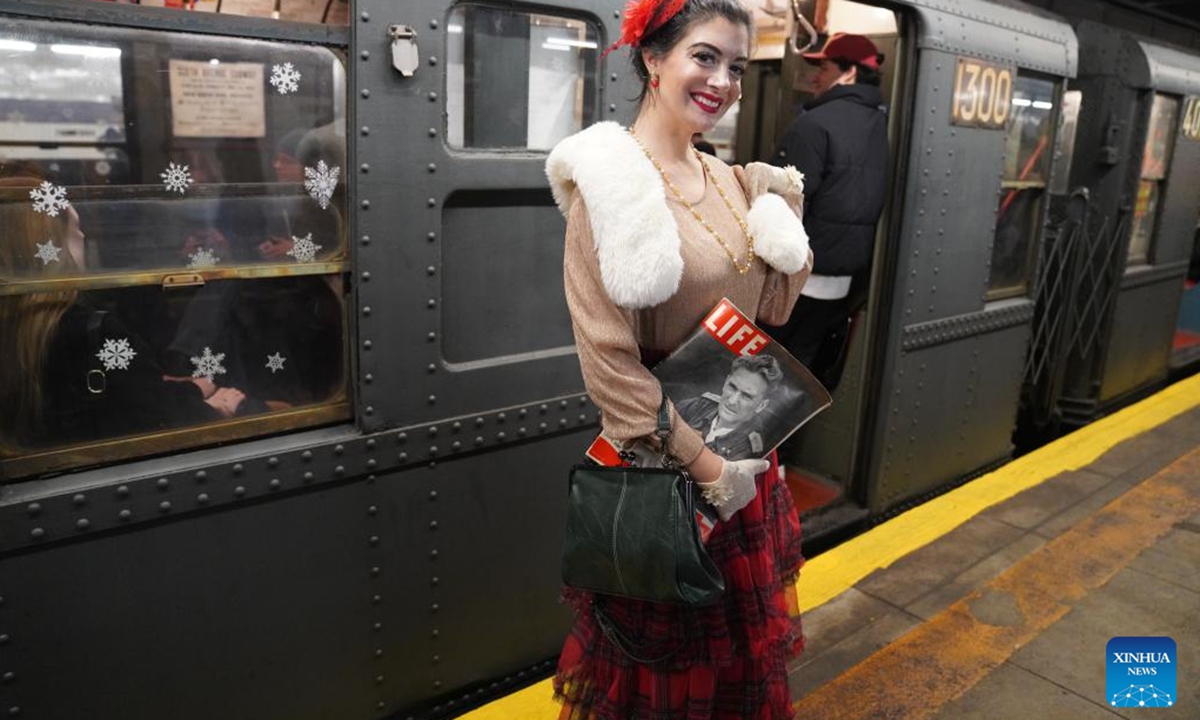 A woman in vintage clothing poses in front of the Holiday Nostalgia Train in New York City, the United States, on Dec. 14, 2025.
Holiday Nostalgia Train, vintage 1930s train cars, is running every Sunday in December to celebrate the holiday season here in New York, taking passengers to step back in time. (Xinhua/Zhang Fengguo)