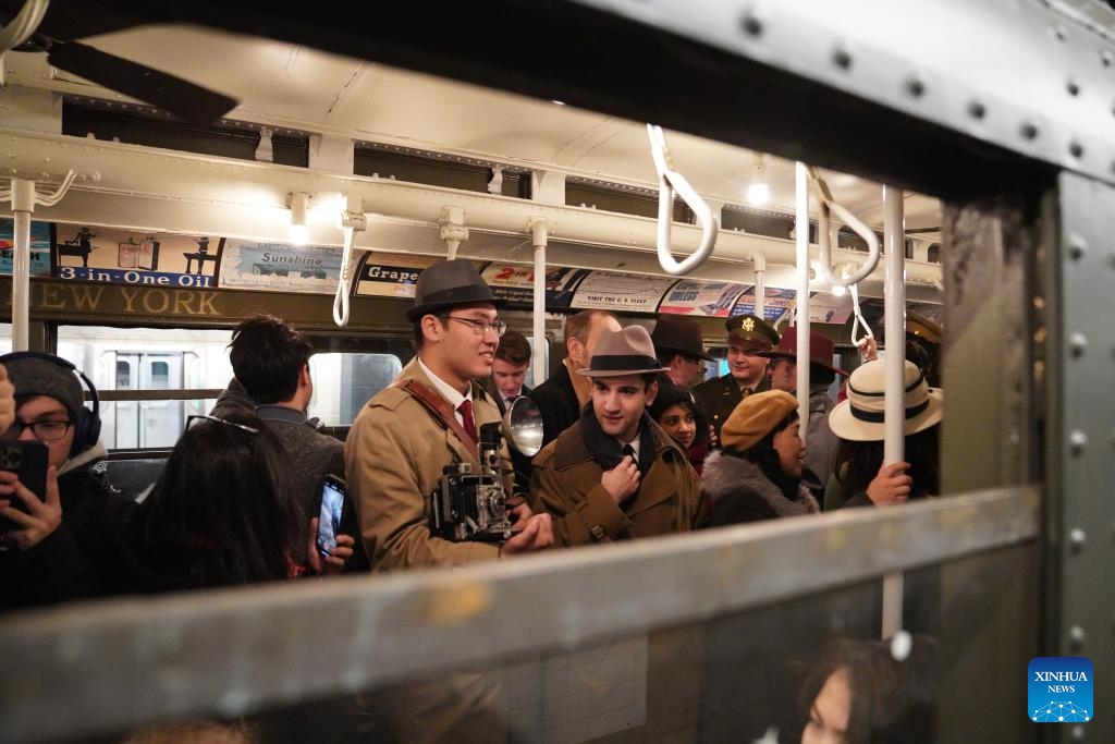 People in vintage clothing pose in front of the Holiday Nostalgia Train in New York City, the United States, on Dec. 14, 2025.
Holiday Nostalgia Train, vintage 1930s train cars, is running every Sunday in December to celebrate the holiday season here in New York, taking passengers to step back in time. (Xinhua/Zhang Fengguo)