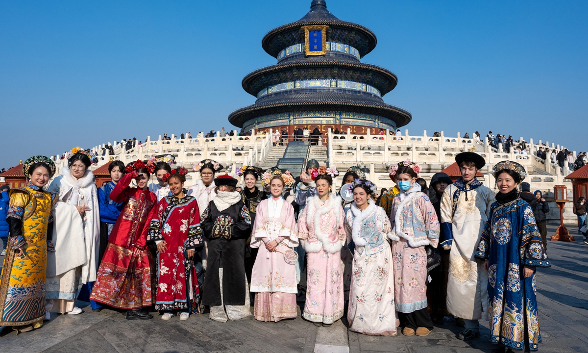 Foreign tourists pose for a group picture at the Temple of Heaven Park in Beijing on December 11, 2025. Photo: VCG