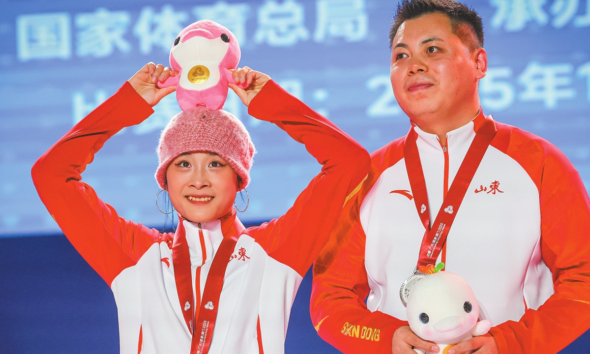 Guo Pu poses with a mascot at the 15th National Games in Guangzhou, South China's Guangdong Province, on November 18, 2025. Photo: VCG
