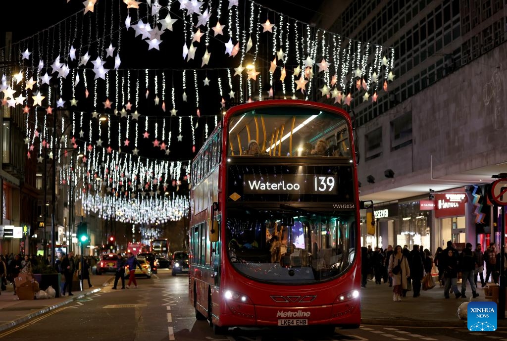 A double-decker bus runs on Oxford Street decorated with lights in London, Britain, on Dec. 17, 2025. (Xinhua/Li Ying)