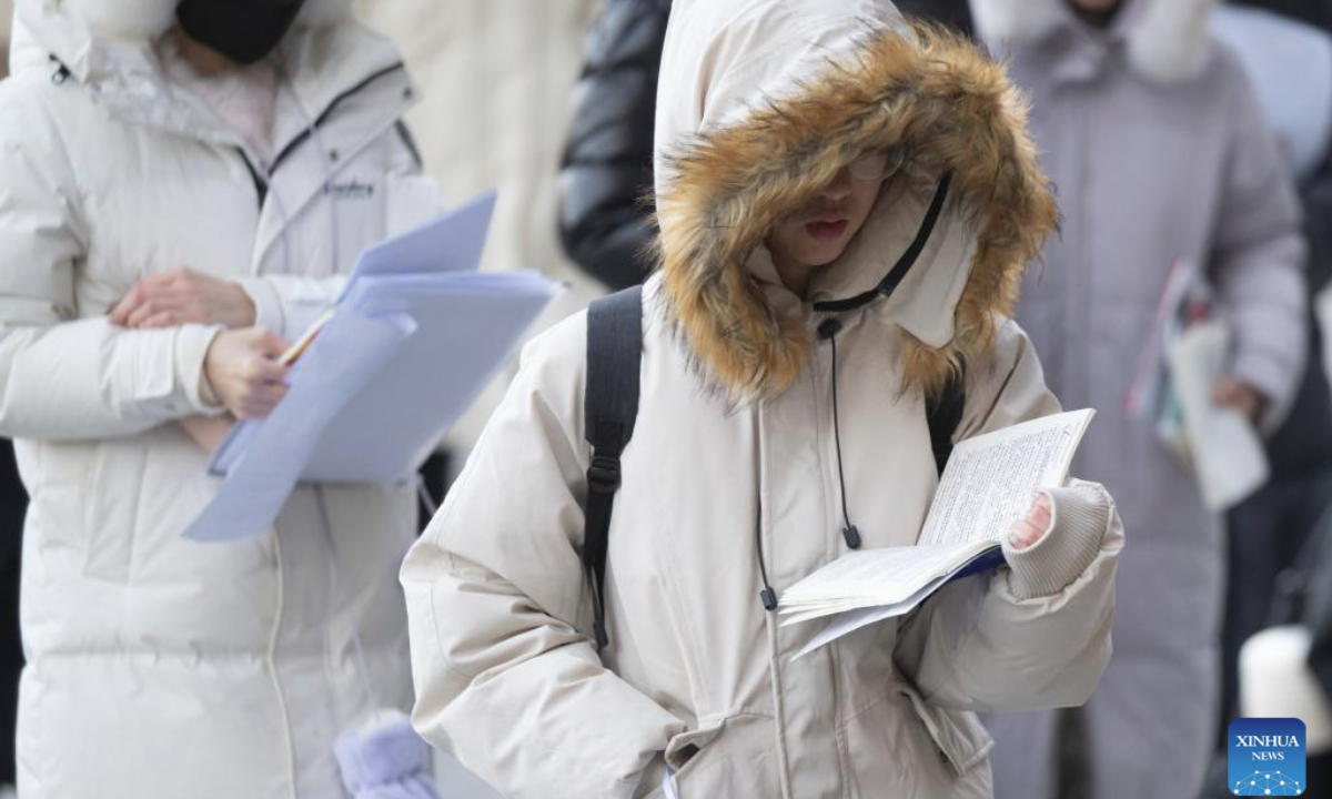 Examinees prepare to enter an examination site for the 2026 postgraduate entrance exam in Harbin, northeast China's Heilongjiang Province, Dec. 20, 2025. China's national exam for postgraduate enrolment kicked off on Saturday. (Xinhua/Zhang Tao)