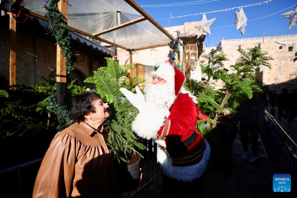 A man dressed as Santa Claus interacts with a woman during a Christmas celebration in Jerusalem on Dec. 18, 2025.

The Christmas celebrations came amid a fragile ceasefire between Israel and Hamas following two years of conflict in the Gaza Strip. Scenes of holiday activities highlighted moments of relative calm and a desire for normalcy among local communities during the Christmas season. (Photo by Jamal Awad/Xinhua)