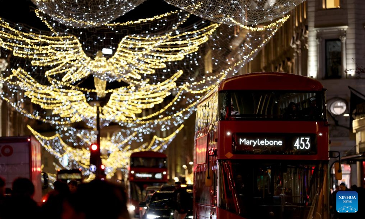 A double-decker bus runs on Regent Street decorated with lights in London, Britain, on Dec. 17, 2025. (Xinhua/Li Ying)