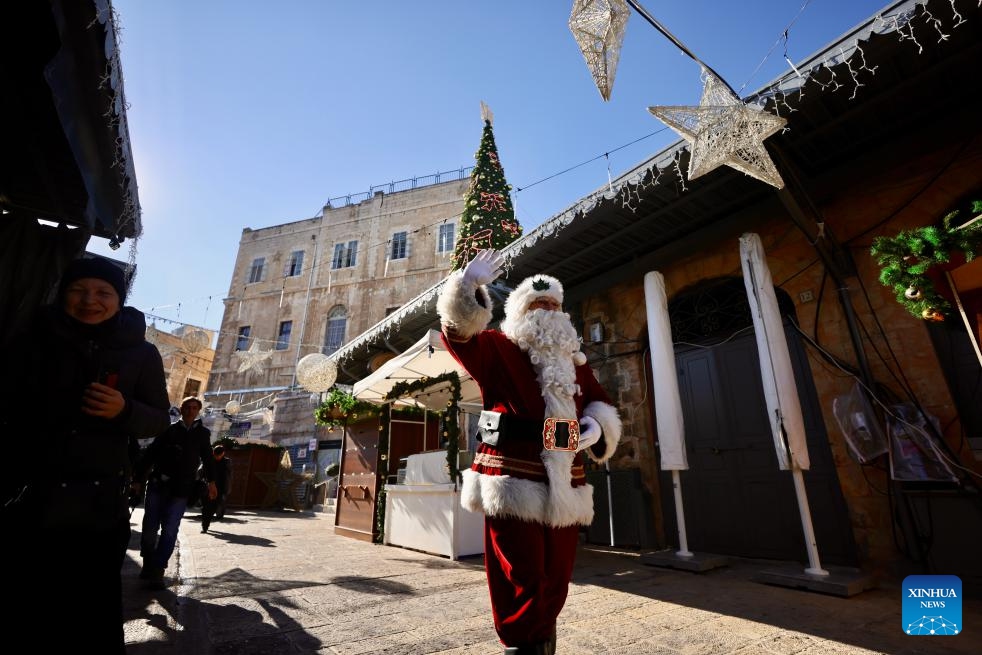 A man dressed as Santa Claus walks through a street adorned with Christmas decorations in Jerusalem on Dec. 18, 2025.

The Christmas celebrations came amid a fragile ceasefire between Israel and Hamas following two years of conflict in the Gaza Strip. Scenes of holiday activities highlighted moments of relative calm and a desire for normalcy among local communities during the Christmas season. (Photo by Jamal Awad/Xinhua)