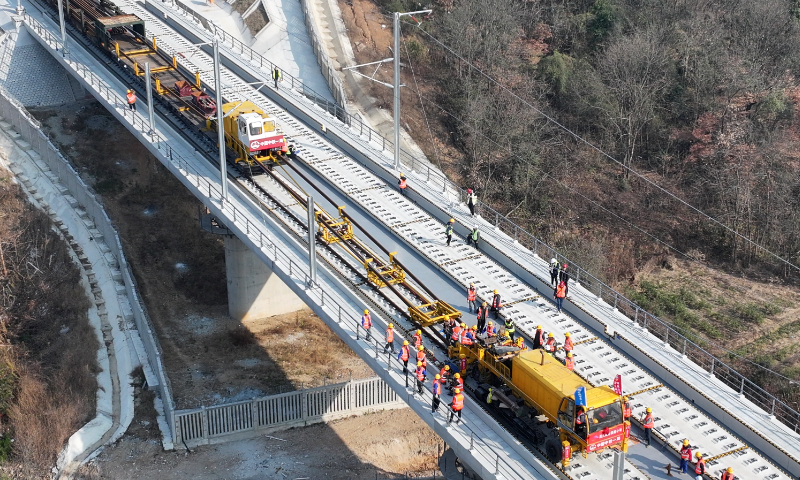 Workers lay tracks for the Nanchang-Jiujiang High-Speed Railway (HSR) in Jiujiang, East China's Jiangxi Province, on December 19, 2025. The railway line, designed for speeds of up to 350 kilometers per hour, requires 295.28 kilometers of rail, and is set for completion in May 2026. As a key segment of the Beijing-Hong Kong HSR, it will enhance China's north-south rail network. Photo: VCG